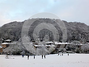 Winter scene in hebden bridge with houses with snow covered roofs on the houses and frozen trees