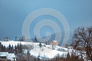 Winter scene house on mountains landscape. Stone snowy mountains.