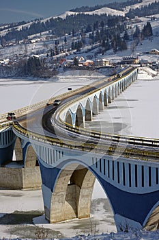Winter scene at Poiana Largului viaduct with frozen lake of Bicaz