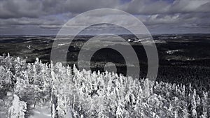 Winter scene at a ski resort at the natural park. Clip. Aerial view of the forested valley and cold winter ground.