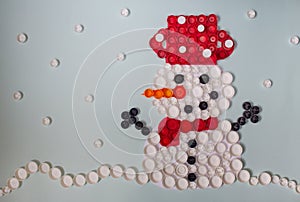 Winter scene with  snowman and snowflakes mosaic decoration made of plastic bottle caps  Handmade crafts. Recycling art