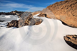 Winter scene of Teide national park at sunset with volcanic rocks and snow, in Tenerife, Canary islands, Spain.