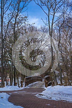 Winter Scene with wooden Bridge over the DuPage River West Branch in Naperville