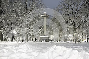 Winter scenery, cross in the square