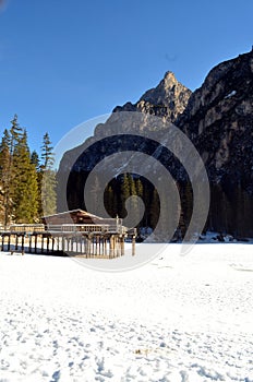 Winter scenery of frozen lake Braies at Dolomites alps Italy
