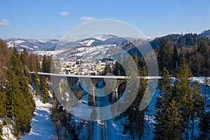 Winter scenery in Silesian Beskids mountains. Railwai viaduct in Wisla Glebce. Aerial view from above. Landscape photo captured