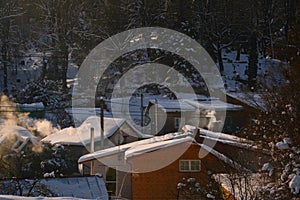 winter scenery with smoke coming from house chimneys