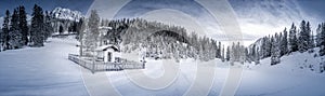 Winter scenery with snowy forest and chapel