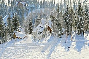 Winter scenery with snowy mountains and beautiful wooden chalets. Fantastic winter landscape