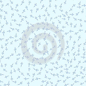 Winter seamless pattern with bird footprints on a bright-blue snowy background