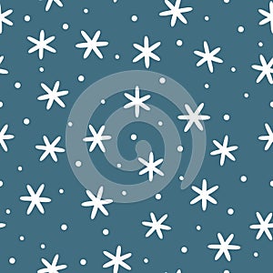 Winter seamless pattern. White snowflakes on blue background.