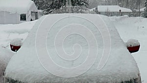 Winter season: car, road and house covered by snow.