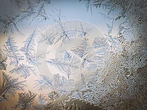 Winter Season Fantasy World Theme Concept: Macro Image Of Colorful Light Frosty Window Glass Natural Ice Patterns