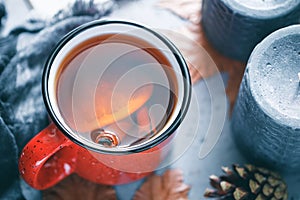 Winter season hot tea in a red ceramic mug