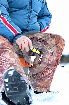 Winter season old man fishing on lake