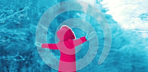 Winter season is open! Abstract silhouette of woman raising her hands up enjoys winter weather on snowy forest background