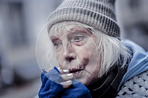 Portrait of a sad senior woman feeling cold photo