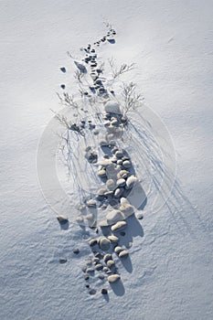 Winter serenity with stone path and shadows in snowy landscape