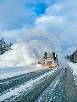 Winter service truck for snow plow clearing road after winter snowstorm