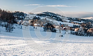 Winter Silesian Beskids mountains with dispersed settlement and Ochodzita hill in Poland