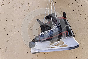 Winter skates hang on the wall as a symbol of career completion