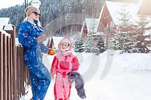 Winter, ski - Little girl with mother in ski resort.