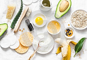 Winter skin care. Homemade natural ingredients for a nourishing face mask on a light background, top view.