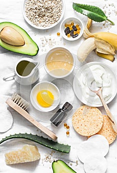 Winter skin care. Homemade natural ingredients for a nourishing face mask on a light background, top view.