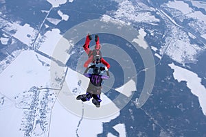 Winter skydiving. Two skydivers are training in the sky.