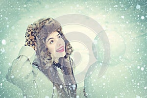 Winter snow blue toned. Joyful Beauty young woman Having Fun with snowman in Winter Park. Funny snowmen. Happy smiling