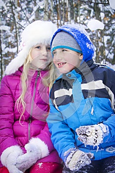 In winter, the snow-covered forest boy with blond girl talk.