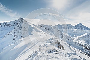 Winter snow covered mountain peaks in Europe. Great place for winter sports.