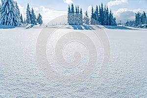 Winter snow with frozen mountains landscape in blur. Snow texture with bokeh, light, selective focus. Snowy white texture. Winter