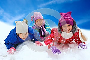 Winter snow, happy children sledding at winter time