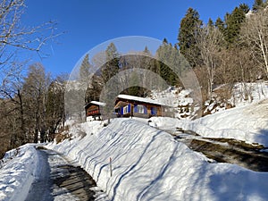 Winter snow idyll along the rural alpine road above the Lake Walen or Lake Walenstadt (Walensee) and in the Swiss Alps photo