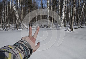 Winter. snow. road. the finger of the hand shows the direction of movement.