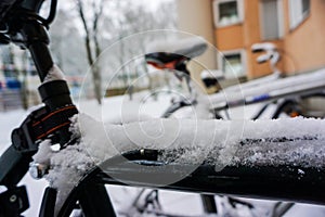 Winter snow street with motorcycle on the forground and building