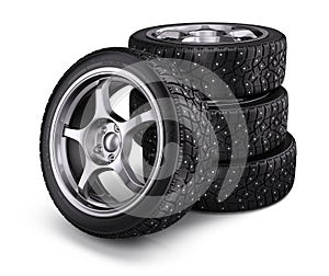 Winter snow tyres with metal spikes on white background