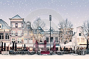 Winter snow view of the famous Dutch Waagplein with pubs and restaurants in Alkmaar, The Netherlands