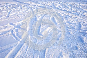 Winter snowy ground with tire mark. Way covered in lot of snow white tire print as background.