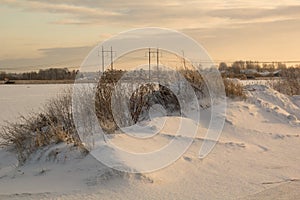 In winter, snowy hills lay in the fields