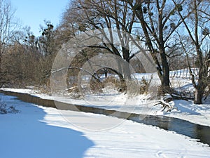 Winter snowy landscape with small river