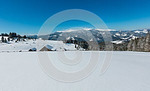 Winter snowy mountains, and lone farmstead