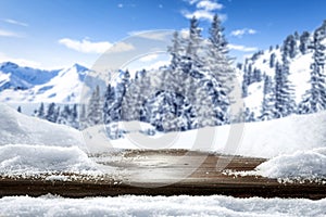 Winter and snowy mountains with wooden board backround. Tall spruce covered with snow and sunny sky background.