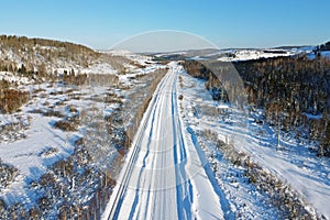 Winter snowy road in Siberia, view from copter