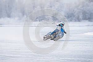 Winter Speedway. Racers unmarked drive on the ice road