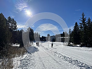 A winter sport cross-country ski trail around a frozen alpine Heidsee lake (Igl Lai lake) in the resort of Lenzerheide