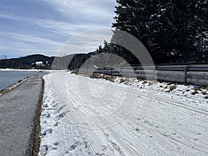 A winter sport cross-country ski trail around a frozen alpine Heidsee lake (Igl Lai lake) in the Swiss winter resorts