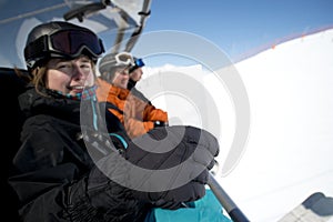 Winter sport girl in chair lift with ticket