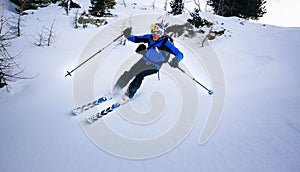 Winter sport: man skiing in powder snow.